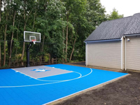 Angled view from front left of blue and titanium residential court with custom graphic in Bedford, MA.