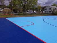 Full view of finished basketball court and hockey combo in Burlington, MA, rougly matching the perspective of the prior two pictures before and during installation.