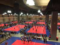 Indoor sport tile volleyball courts in convention center for New England Regional Volleyball Association (NERVA) Winterfest 2020 tournament in Hartford, CT. Wide view of a bunch of the courts in use.