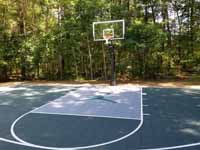 Slate green and titanium residential  basketball court with Michael Jordan custom logo in Duxbury, MA.