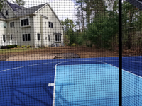 Royal and ice blue backyard basketball court with custom name logo, resurfaced on old asphalt court, in Marion, MA.