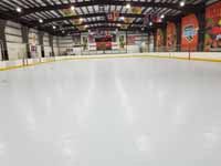 We traveled to Kapolei, Hawaii and inside to resurface two inline skate hockey rinks with Versacourt Speed Indoor tile. This is a view of most of the first court after surface is installed but before lines have been fully applied.
