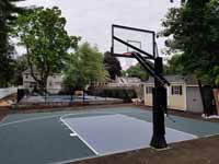 Home backyard basketball court in slate green and titanium colors in Lexington, MA.