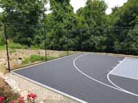 Charcoal and titanium Cape Cod backyard basketball court in Barnstable village of Marstons Mills, MA.