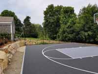 Charcoal and titanium Cape Cod backyard basketball court in Barnstable village of Marstons Mills, MA. Comparative view to previous before picture.
