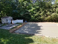 Light blue, red, and royal blue residential basketball court in North Attleboro, MA. Recently poured base shown here, waiting for cement to dry and cure.