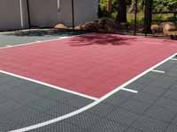 Residential slate green and red basketball court in Norwell, MA.