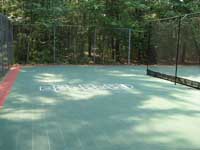 Restoration and resurfacing of large tennis court into multicourt with hopscotch and shuffleboard for a condo complex in Duxbury, Massachusetts. Separate area for kids, featuring hopscotch lines.