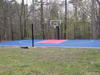 Backyard basketball court, with adjustable center net making it a multicourt for other games, in Sudbury, MA.