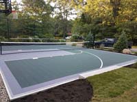 Backyard basketball court multicourt with added tennis and volleyball net is the sort of thing you might find in Andover, MA or a yard like yours.