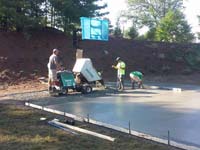 Slab being poured and smoothed for pending install of home basketball court in Bridgewater, MA.