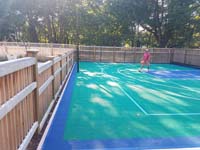 This emerald green and royal blue home basketball court is one you might find in Carlisle, MA or a yard like yours.