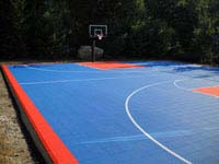 Full royal blue and orange residential basketball court installed in Bellingham, MA.