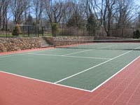 Residential rust red and green tennis court installation in Newport, RI.