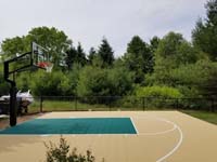 View of tan and green home basketball court in Easton, MA.