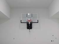 Basketball hoop installed on a garage wall.