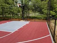 View of red and titanium home basketball court in Groton, MA.