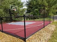 Red basketball court with silver-looking titanium colored key, installed in a side yard in Groton, MA.