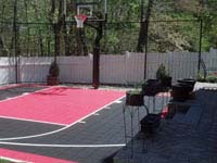 Black and red basketball court installed off-season in Hingham, MA. No need to wait for summer.