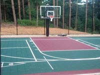 Focus on hoop side of basketball and multiple game or sport usage court in Kingston, MA.