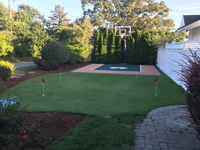 Backyard basketball court featuring Celtics logo and adjacent putting green by our partner is the sort of thing you might find in Manchester-by-the-Sea, MA or a yard like yours.
