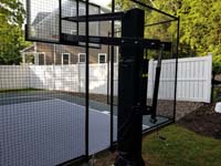 Rear view of goal system installed with slate green and titanium silver/grey basketball court in Needham, MA.