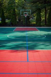 Large backyard multicourt for sports like basketball, tennis and volleyball in Pembroke, MA.