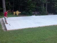 Cement has been poured and cured for a graphite and olive green court in Raynham, MA.