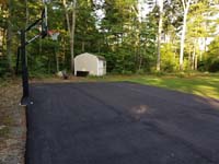 Asphalt court waiting for addition of jade green and blue Versacourt basketball tile in Rehoboth, MA.