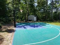 Blue and gray residential basketball court in Easton, MA.