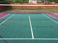 Backyard basketball court in Sudbury, MA, focusing on optional net making it a multicourt for tennis and volleyball.