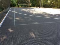Black and grey home backyard basketball court in Wellesley, MA.