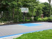 Titanium and light blue backyard basketball court in West Bridgewater, MA.