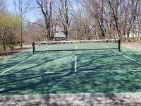 Rare dedicated pickleball court in green with white lines in Andower, MA.