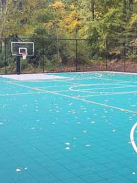 One end of large basketball court in Bolton, MA, also lined for pickleball with a rollable portable net.