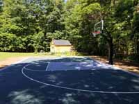 Slate green and titanium backyard basketball court with Michael Jordan custom logo in Duxbury, MA.