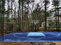 Angled view from front left of blue and titanium residential court with custom graphic in Bedford, MA.