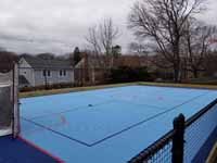View of most of large blue basketball and hockey multicourt in Hingham, MA.