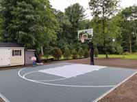 Home backyard basketball court in slate green and titanium colors in Lexington, MA.