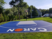 Central portion of navy and light blue basketball court surface in Foxboro, MA.