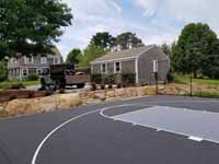 Charcoal and titanium Cape Cod backyard basketball court in Barnstable village of Marstons Mills, MA.