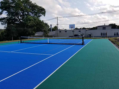 Municipal tennis court with portable net in Middleboro, MA.