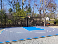 Angled view of most of basketball court from front left toward hoop in Middleton, MA.
