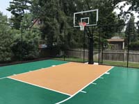 View of key and hoop portion os small basketball court in Needham, MA, in shades of green and peach.