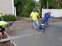 Residential slate green and red basketball court in Norwell, MA. Putting in cement for concrete court base.
