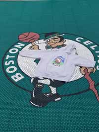 Custom Celtics logo wearing a BCM logo sweatshirt on a basketball court installed in Swampscott, MA.