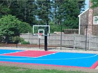 Light blue and red backyard basketball court, hoop and rebound fence in Halifax, MA.