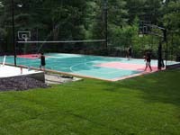 Backyard basketball and tennis surface, hoops, lights, adjustable net, and rebound fence in Pembroke, MA.