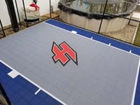 Small blue and grey basketball court in Braintree, MA, featuring a custom red H logo.