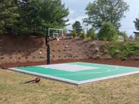 Bridgewater, MA courts a sport surface in emerald green and titanium low impact tiles in a yard like yours.